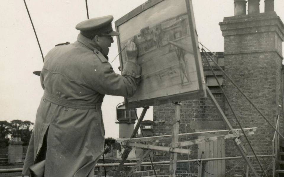 Barnett Freedman painting on a rooftop in France (1940)